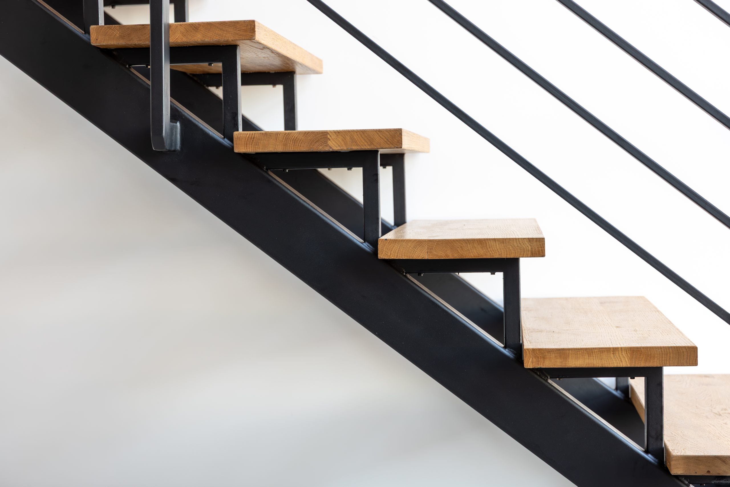 Step detail closeup. Wood on black steel. Industrial interior.